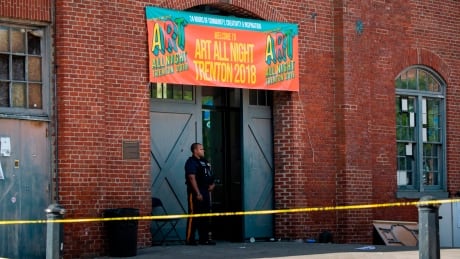 Police officers inspect the crime scene at the Roebling Market on June 17, 2018, the morning after a shooting at an all-night art festival injured 20 people and left one suspect dead in Trenton, New Jersey. (Photo by DOMINICK REUTER / AFP) (Photo credit should read DOMINICK REUTER/AFP/Getty Images) AFP_1637YM