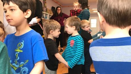 Preschoolers at the Turtle Island Childcare Centre in St. John's link arms while throat singing. Children throat singing