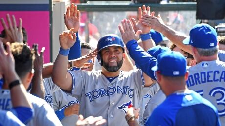 Kendrys Morales is congratulated in the dugout after hitting the go-ahead home run for the Blue Jays in Toronto's 7-6 win over the Los Angeles Angels. 100411502