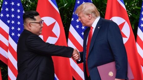 North Korea leader Kim Jong-un, left, and U.S. President Donald Trump shake hands at the conclusion of their meetings at the Capella resort on Sentosa Island in Singapore on June 12. A leaked U.S. intelligence report and an analysis of satellite data suggest the North may be continuing its nuclear and missile activities. North Korea Denuclearization