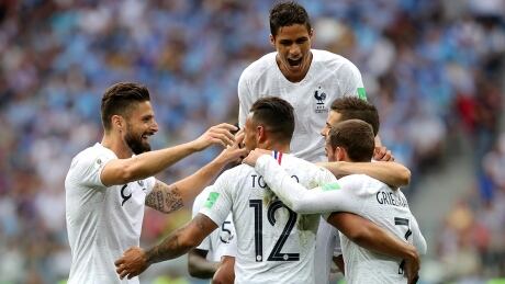 Defender Raphael Varane, top, scored the winner as France defeated Uruguay to set up a semifinal showdown with either Brazil or Belgium. Varane