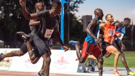 Aaron Brown, left, narrowly edged Bismark Boateng, centre, to win the men's 100-metre final at the Canadian championships in Ottawa earlier this month. brown-aaron