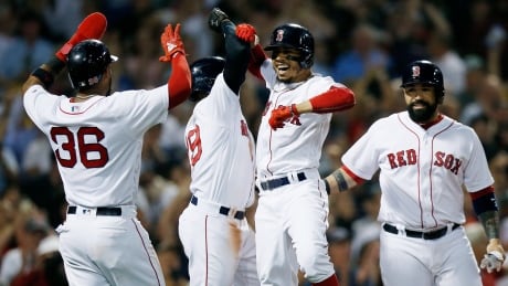 Boston Red Sox's Mookie Betts, centre right, celebrates his grand slam that drove in Eduardo Nunez (36), Jackie Bradley Jr., centre left, and Sandy Leon during the fourth inning against the Toronto Blue Jays on Thursday. jays-sox