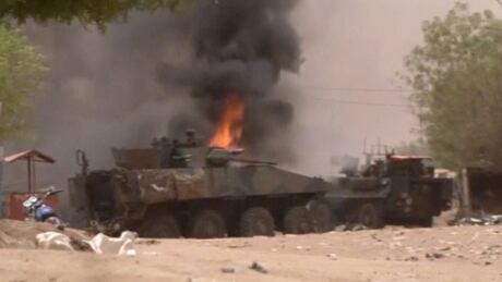 A still image taken from a video shows an armoured personnel carrier on fire after a car bomb attack in Gao, northern Mali July 1, 2018. MALI-VIOLENCE/FRANCE