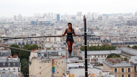 Tightrope walker Tatiana-Mosio Bongonga advances on a tightrope as she scales the Monmartre hill towards the Sacré Coeur Basilica. FRANCE-TIGHTROPE/PARIS