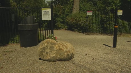 A bouquet of flowers rests on a rock at the gates to South Surrey's 1001 Steps. A teen aged boy was killed near the site on July 4, 2018. 1001 Steps Surrey B.C. flowers on rock at gate