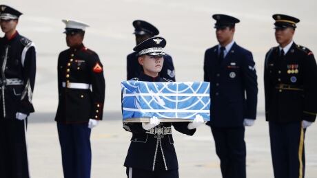 A soldier carries a casket containing a remain of a U.S. soldier who was killed in the Korean War during a ceremony at Osan Air Base in Pyeongtaek, South Korea, Friday, July 27, 2018. The U.N. Command said the 55 cases of war remains retrieved from North Korea will be honored at a ceremony next Wednesday at a base in South Korea. (Kim Hong-Ji/Pool Photo via AP) APTOPIX South Korea US North Korea War Remains