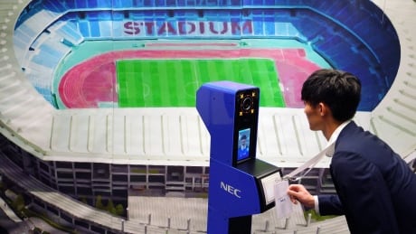 A staff demonstrates a new face recognition system used for the Tokyo 2020 Olympic and Paralympic Games during a press conference in Tokyo Tuesday, Aug. 7, 2018. The NeoFace technology developed by NEC Corp. will be used across the Olympics for the first time as Tokyo organizers work to keep security tight and efficient at dozens of venues during the 2020 Games. Olympics Tokyo 2020 Security