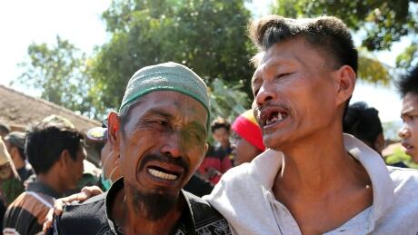 Relatives react as rescue teams recover the bodies of victims killed in an earthquake in North Lombok, Indonesia, on Tuesday, Aug. 7, 2018. Indonesia Earthquake Photo Gallery
