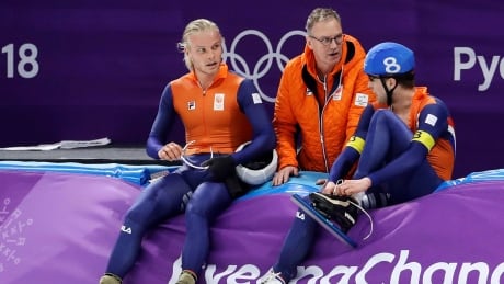 Bronze medalist Koen Verweij of The Netherlands, left, and Sven Kramer, right, talk to coach Geert Kuiper during the 2018 Winter Olympics. On Friday, Kuiper was hired by Speed Skating Canada as a technical adviser. kuiper-geert-081018