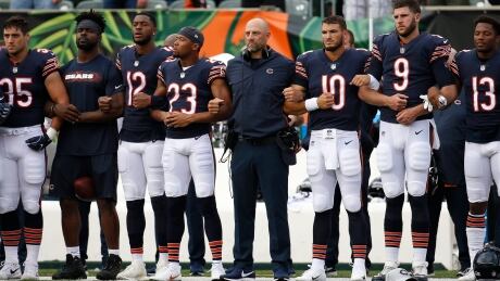 The Chicago Bears lock arms during the national anthem before the team's pre-season game against the Cincinnati Bengals on Thursday. bears-bengals