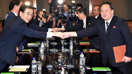 South Korean Unification Minister Cho Myoung-gyon, left, shakes hands with his North Korean counterpart Ri Son-gwon after their meeting at the northern side of Panmunjom in the Demilitarized Zone, North Korea, on Monday, Aug. 13, 2018. The rival Koreas announced Monday that North Korean leader Kim Jong-un and South Korean President Moon Jae-in will meet in Pyongyang sometime in September. North Korea Koreas Summit