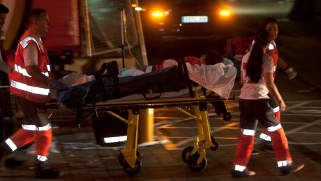 Several Red Cross paramedics transport an injured person to hospital after a boardwalk collapsed near of the sea during a concert in Vigo, northwestern Spain, on Aug. 12, 2018. SPAIN ACCIDENT