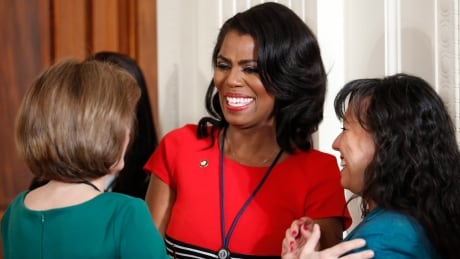 Omarosa Manigault, then-director of communications for the White House Office of Public Liaison, centre, speaks in the East Room of the White House in Washington, before the start of U.S. President Donald Trump's news conference, on Feb. 16, 2017. Omarosa Manigault Newman says she has concluded, after years of defending Donald Trump, that he is a bigot. She writes in a new book, "I had to go through the pain of witnessing his racism with my own eyes, and hearing it with my own ears, many times, until I couldn't deny it any longer." Trump Omarosa