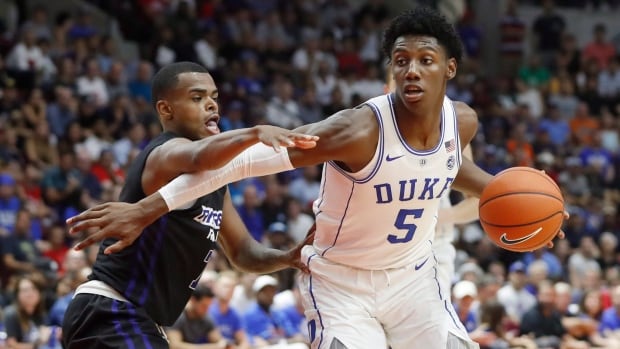 Duke Blue Devils' R.J. Barrett is guarded by Ryerson Rams' Myles Charvis, left, during their exhibition basketball game on Wednesday. duke-ryerson
