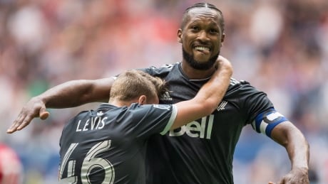 Vancouver's Kendall Waston, right, scored both of his goals off headers as the Whitecaps tied the New York Red Bulls 2-2 on Saturday evening. kendall-waston