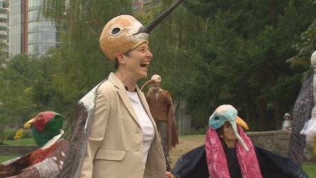 A woman dressed as a hummingbird rehearses for a bird parade as part of Vancouver's International Bird Festival, which begins on August 20, 2018. Birds on Parade Coal Harbour bird parade