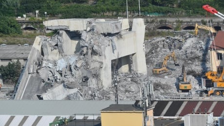 A general view showing a part of the partially collapsed Morandi Bridge is shown in Genoa on Sunday. Italian authorities, worried about the stability of remaining large sections of the bridge, have evacuated about 630 people from nearby apartments. ITALY GENOA MORANDI BRIDGE COLLAPSE AFTERMATH