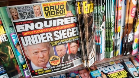 FILE - This July 12, 2017, file photo shows the cover of an issue of the National Enquirer featuring President Donald Trump at a store in New York. Karen McDougal, a former Playboy model who said she had a 10-month affair with President Donald Trump, settled her lawsuit Wednesday, April 18, 2018, with a supermarket tabloid over an agreement that prohibited her from discussing the relationship publicly. Trump National Enquirer