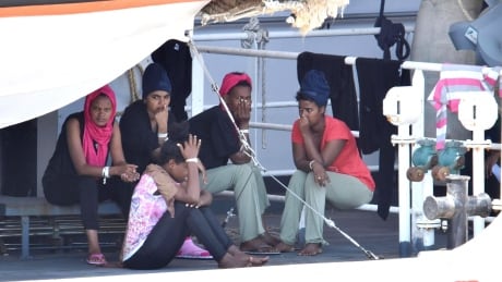 Migrants wait to disembark from Italian Coast Guard ship Diciotti in the port of Catania, on Friday. The vessel arrived nearly a week ago with 177 migrants on board, but several children were allowed to disembark. ITALY MIGARTION