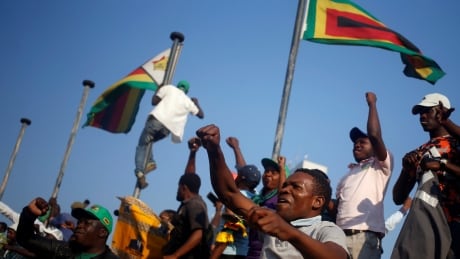 Supporters of President Emmerson Mnangagwa's ruling ZANU-PF party celebrate after the Constitutional Court confirmed Mnangagwa's disputed July 30 election victory in Harare, Zimbabwe August 24, 2018. ZIMBABWE-ELECTION/COURT