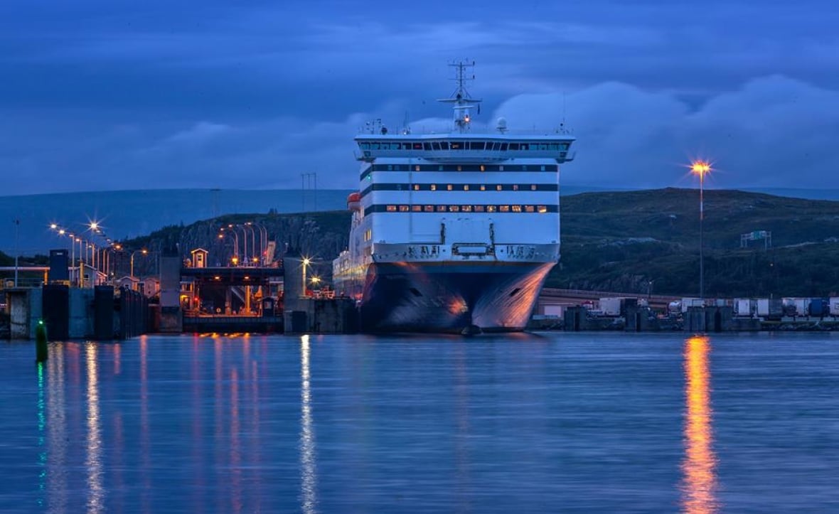 A ferry sits at the port in Port aux Basques at twilight.