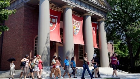 FILE - In this Aug. 30, 2012, file photo, a tour group walks through the campus of Harvard University in Cambridge, Mass. The Justice Department has sided with Asian-American students suing Harvard University over the Ivy League school's consideration of race in its admissions policy. (AP Photo/Elise Amendola, File) Havard Race In Admissions