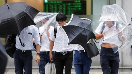 Passersby using umbrellas struggle against strong wind and rain caused by Typhoon Jebi, in Tokyo, Japan, on Sept. 4, 2018. ASIA-STORM/JEBI