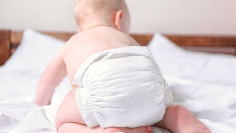 429348994 Baby crawling away from camera, wearing disposable diaper