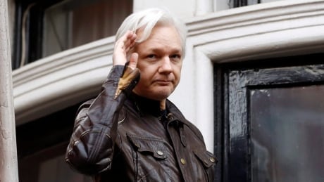 FILE - In this May 19, 2017 file photo, WikiLeaks founder Julian Assange greets supporters from a balcony of the Ecuadorian embassy in London. The Justice Department's indictment Friday, July 13, 2018 of 12 Russian military intelligence officers for U.S. election hacking undermine denials by WikiLeaks founder Julian Assange that the Russian government was the source of stolen Democratic Party emails published by the anti-secrecy organization. (AP Photo/Frank Augstein, File) WikiLeaks-Russian Hackers