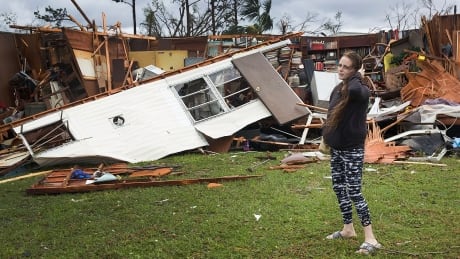 PANAMA CITY, FL - OCTOBER 10: Haley Nelson stands in front of what is left of one of her fathers trailer homes after hurricane Michael passed through the area on October 10, 2018 in Panama City, Florida. The hurricane hit the Florida Panhandle as a category 4 storm. (Photo by Joe Raedle/Getty Images) Hurricane Michael destroyed trailer homes Florida