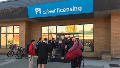 People wait outside an ICBC branch, many of them on standby to take a road test. ICBC road tests