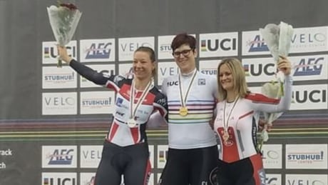 Transgender woman Rachel McKinnon, centre, celebrates her first-place finish at UCI Masters Track Cycling World Championship in Los Angeles on Sunday. McKinnon wins gold