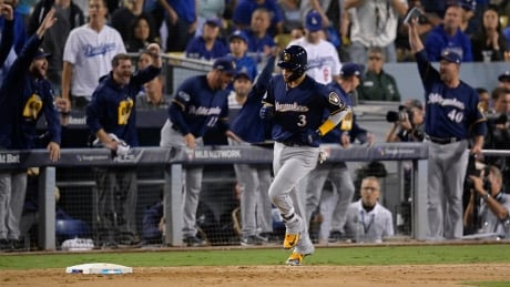 Milwaukee Brewers' Orlando Arcia hits a two-run home run during the seventh inning of Game 3 against the Los Angeles Dodgers on Monday night. brewers-dodgers