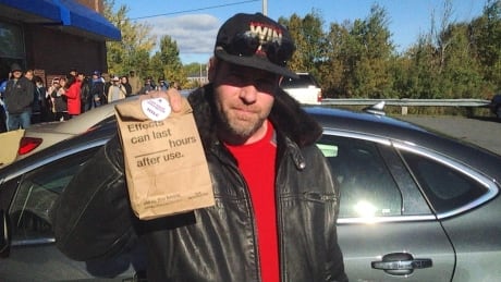 Fiddler Ashley MacIsaac shows off his purchase after becoming the first person in Cape Breton to legally buy recreational marijuana. Ashley MacIsaac NSLC marijuana