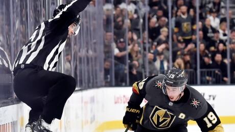 Linesman Brandon Gawryletz takes a flying leap for the good of the game in Las Vegas. APTOPIX Sabres Golden Knights Hockey