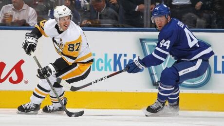 Pittsburgh's Sidney Crosby watches his pass as the Leafs' Morgan Rielly pursues during their game Thursday in Toronto.
775220388CA010_peng_leaf