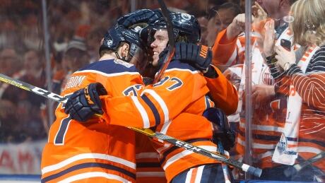 Edmonton Oilers' Oscar Klefbom (77), Connor McDavid (97) and Leon Draisaitl (29) celebrate an overtime win against the Boston Bruins. bruins-oilers