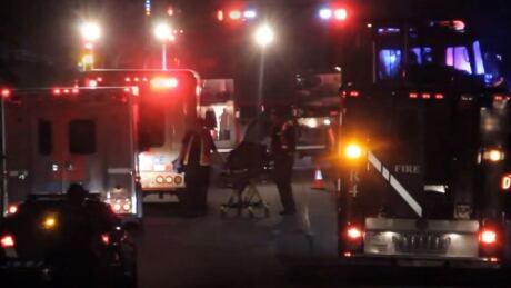 Emergency personnel remove the body of the victim of a targeted shooting Oct. 18 from the crime scene in Abbotsford. Abbotsford shooting