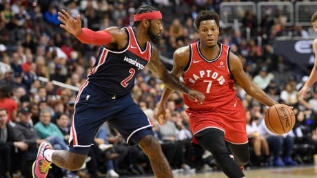 Toronto Raptors guard Kyle Lowry, right, scored 28 points and added 12 assists in a 117-113 win over the Washington Wizards in Washington, D.C., on Saturday. raptors-wizards-102018-620