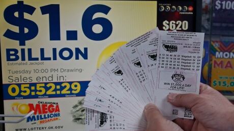 A customer, who did not want to be identified, displays the $200.00 worth of Mega Millions tickets he bought at Downtown Plaza convenience store in Oklahoma City, Tuesday, Oct. 23, 2018. Lottery Jackpot