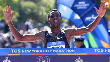Ethiopia's Lelisa Desisa crosses the finish line 1.99 seconds ahead of countryman Shura Kitata in the men's division at the New York City Marathon on Sunday. desisa-lelisa-181104-1180