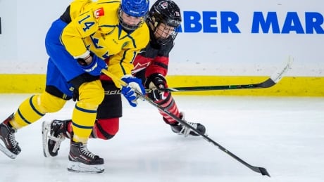 Sweden forward Sabina Kuller battles for the puck with Canada forward Loren Gabel during the third period. Canada went on to defeat Sweden 6-1. HKW Four Nations 20181106