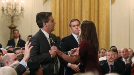 A White House intern reaches for and tries to take away the microphone held by CNN correspondent Jim Acosta as he questions U.S. President Donald Trump during a news conference at the White House in Washington, U.S., November 7, 2018. Picture taken November 7, 2018. USA-ELECTION/TRUMP
