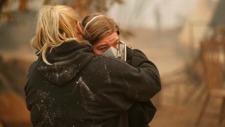 Krystin Harvey, left, comforts her daughter Araya Cipollini at the remains of their home burned in the Camp Fire, Saturday, Nov. 10, 2018, in Paradise, Calif. California Wildfires Photo Gallery