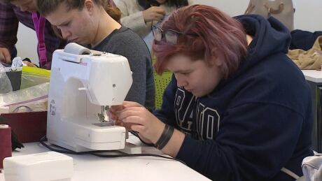 A participant at a drop-in clothing fix-in event at the Vancouver Public Library. More than 130 people attended on Saturday. Clothing fix-it