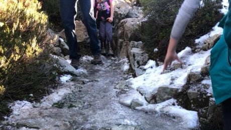 This photo from North Shore Rescue shows hikers trying to walk around an icy trail. North Shore mountains icy trail