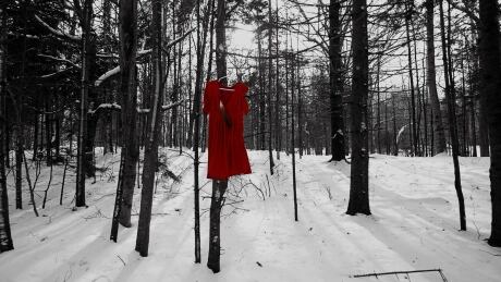 'I see the shadows coming through from the sun beaming through the trees, and you just feel it,' says Patricia Bourque of this photograph. Red dress photography by Patricia Bourque