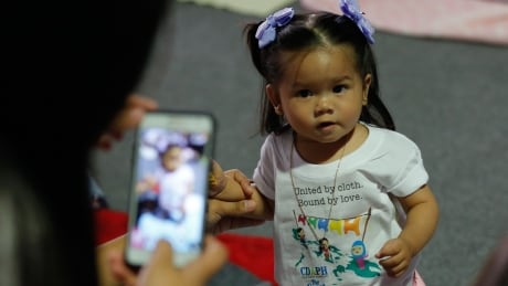 A Filipino mother takes a picture of her daughter wearing a cloth diaper during the 'Great Cloth Diaper Change' in Pampanga, north of Manila, Philippines, 23 April 2016. The 'Great Cloth Diaper Change' is a global event aimed to promote the use of cloth diapers as an earth-friendly, economical and safe choice for babies. The event is a continuation of Earth Day celebrations. PHILIPPINES ENVIRONMENT CLOTH DIAPER