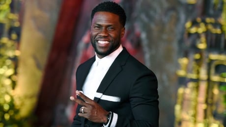 FILE - In this Dec. 11, 2017 file photo, Kevin Hart arrives at the Los Angeles premiere of "Jumanji: Welcome to the Jungle" in Los Angeles. A man has been charged with trying to extort money from Kevin Hart by threatening to release video he had secretly shot of the actor and comedian with a woman in Las Vegas. Los Angeles County prosecutors charged 41-year-old Jonathan Jackson on Wednesday May 2, 2018, with attempted extortion and extortion by threatening letter. Jackson is jailed on $100,000 bail. (Photo by Jordan Strauss/Invision/AP, File) People-Kevin Hart